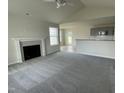 Spacious living room with a fireplace, high ceilings, and ample natural light at 116 Lotus Ave, Smithfield, NC 27577