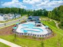 Aerial view of community pool with lounge chairs and landscaping at 655 Georgia'S Landing Pkwy # 99, Raleigh, NC 27603