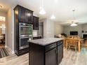 Kitchen with island, stainless steel double oven, and view of the dining area at 60 Sutherland Dr, Franklinton, NC 27525