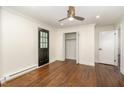 Bright bedroom with hardwood floors, a closet, and a black door at 221 W Dale Dr, Oxford, NC 27565