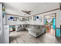 Spacious living room featuring a large sectional sofa and wood-look flooring at 229 Turnipseed Rd, Wendell, NC 27591