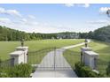 Gated entrance to a large estate with lush lawns at 12660 Boyce Milll Road, Raleigh, NC 27613