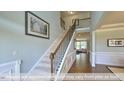 Elegant staircase with iron spindles in a two story foyer at 1765 Old Fields Blvd, Haw River, NC 27258