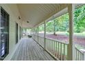 Spacious front porch with wooden flooring and white railings at 6117 Hilbert Ridge Dr, Holly Springs, NC 27540