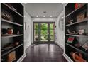 Bright entryway with dark hardwood floors and built-in shelving at 1201 Bancroft St, Raleigh, NC 27612