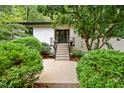 White brick ranch home with a modern entryway and landscaped landscaping at 1201 Bancroft St, Raleigh, NC 27612