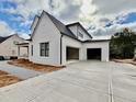 Attached two-car garage with concrete driveway and walkway at 3407 Churchill Rd, Raleigh, NC 27607