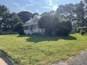 Gray house with a large front yard and mature trees at 409 W Main St, Spring Hope, NC 27882