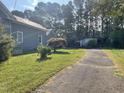 House exterior showing side yard, driveway and detached garage at 409 W Main St, Spring Hope, NC 27882