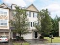 Two-story townhome with two-car garage and manicured lawn at 202 Linden Park Ln, Cary, NC 27519