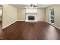 Living room with dark wood flooring and a fireplace at 1517 Wiljohn Rd, Garner, NC 27529