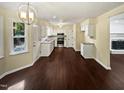 Eat-in kitchen with dark wood flooring and white cabinets at 1517 Wiljohn Rd, Garner, NC 27529