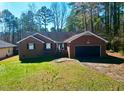 Brick ranch home with attached garage and landscaped yard at 102 Wyoming Dr, Louisburg, NC 27549