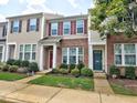 Tan and brick two-story townhome with green door at 812 Cupola Dr, Raleigh, NC 27603