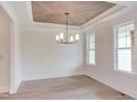 Dining room with hardwood floors, coffered ceiling, and chandelier at 10 Harvest View Way, Franklinton, NC 27525