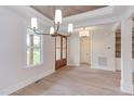Open concept dining room with hardwood floors, chandelier, and access to the foyer at 10 Harvest View Way, Franklinton, NC 27525
