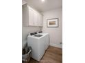 Laundry room with washer, dryer, and overhead cabinets at 11 Claude Creek Dr, Smithfield, NC 27577