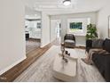 Virtually staged living room featuring a neutral color palette and modern furniture at 1421 Athens Dr, Raleigh, NC 27606