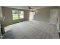 Spacious living room with carpeted floors, fireplace, and large windows at 153 Wynd Crest Way, Benson, NC 27504