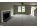 Living room with fireplace, carpet, and neutral color palette at 153 Wynd Crest Way, Benson, NC 27504