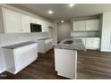 Modern kitchen with white cabinets, granite countertops, and an island at 66 Tulipfield Way, Benson, NC 27504