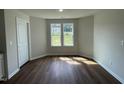 Bright spare bedroom with hardwood floors and large windows at 66 Tulipfield Way, Benson, NC 27504