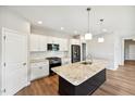 Modern kitchen features white cabinets, granite countertops, and an island at 108 Ascot, Rocky Mount, NC 27804