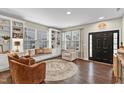 Bright living room featuring built-in shelving and hardwood floors at 220 Clubhouse Dr, Youngsville, NC 27596