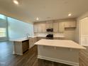 Modern kitchen with an island, stainless steel appliances, and white cabinetry at 824 Putney Hill Rd, Zebulon, NC 27597