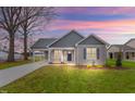 Gray house with a white trim and a blue door at dusk at 806 S Magnolia Ave, Dunn, NC 28334