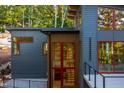 Modern home exterior with a deck and large windows at 23930 Cherry, Chapel Hill, NC 27517