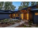 Modern home exterior with a lighted walkway and landscaping at 23930 Cherry, Chapel Hill, NC 27517
