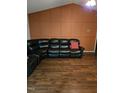 Living room with a sectional sofa and wood-look floors at 95 Crownside Dr, Four Oaks, NC 27524