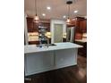 Kitchen boasts an island, stainless steel appliances, and hardwood floors at 95 Crownside Dr, Four Oaks, NC 27524