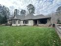 Spacious backyard with grassy lawn and retaining wall at 22005 Turner, Chapel Hill, NC 27517