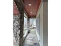 Stone porch with a wood ceiling and access to backyard at 22005 Turner, Chapel Hill, NC 27517