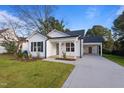 Newly built white house with a carport and landscaping at 603 S Magnolia Ave, Dunn, NC 28334