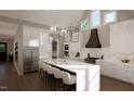 Modern kitchen with white cabinets, large island, and high ceilings at 9417 Rawson Ave, Raleigh, NC 27613