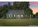 Inviting home exterior at dusk, showcasing curb appeal at 15 Meadow View Ct, Fuquay Varina, NC 27526