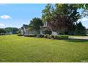 Side view of the house showing mature landscaping at 15 Meadow View Ct, Fuquay Varina, NC 27526