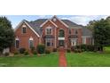 Two story brick house with a landscaped yard at 4600 Scottland Dr, Mebane, NC 27302