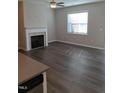 Living room with fireplace and wood-look floors at 727 Putney Hill Rd, Zebulon, NC 27597