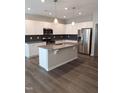 Modern kitchen with island and stainless steel appliances at 727 Putney Hill Rd, Zebulon, NC 27597