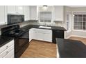 Modern kitchen with black appliances and granite countertops at 104 Deerwalk Ct, Cary, NC 27513