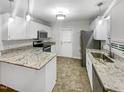 Modern kitchen with granite countertops and stainless steel appliances at 2809 Kempsford Pl, Raleigh, NC 27604