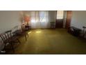 Bright living room with yellow carpet, and wood furniture at 108 Gulf Dr, Dunn, NC 28334