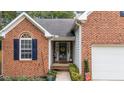 Inviting front entrance with a covered porch and brick walkway at 5629 Keowee Way, Raleigh, NC 27616