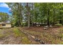 Wooded backyard with stone borders and garden areas at 9336 Baileywick Rd, Raleigh, NC 27615