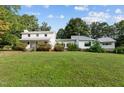 Two-house property with large yard, showcasing a white farmhouse and modern addition at 1021 Dimmocks Mill Rd, Hillsborough, NC 27278