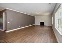 Spacious living room with hardwood floors and a fireplace at 6328 Cardinaux Ln, Holly Springs, NC 27540